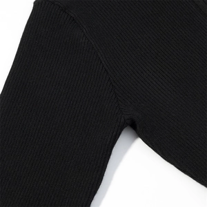 Detailed view of the ribbed knit fabric and stitching on this black fitted jumpsuit