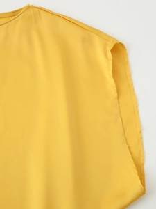 Close-up of yellow sleeveless chiffon top showing fine stitching on neck and armhole