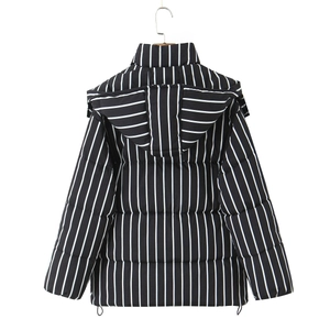 Rear view detail of black and white striped hooded puffer jacket with adjustable hem