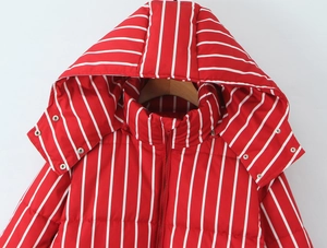 Detail shot of the vertical red and white striped hooded winter puffer jacket with metal snaps