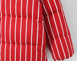 Close-up of red and white vertical striped quilted fabric detail on puffer jacket