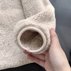 Detail shot of the elastic bound cuffs on the off-white warm fleece jacket for women