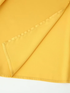 Detailed close-up of the yellow satin fabric with fine rolled hem stitching and soft texture