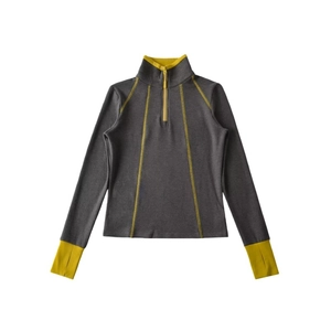 Detailed close-up of grey long-sleeve athletic top with vibrant yellow contrast stitching