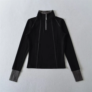 Detail of slim-fit thermal top with half-zip collar and thumbhole cuff design