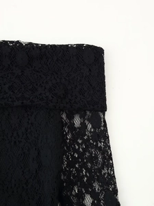 Close-up of high-quality black floral lace fabric showing delicate hollow embroidery