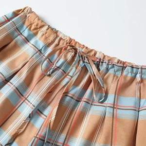 Elastic waistband detail of plaid puff pants with adjustable drawstring and stitch pattern