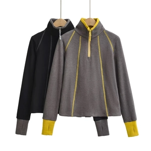 Detail of stand collar half-zip thermal sweatshirt with thumbholes and contrast stitching
