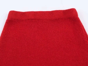 Detail of red ribbed knit waistband showing soft texture and premium elasticity
