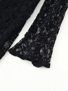 Close-up of intricate black floral lace pattern with elegant cutout details