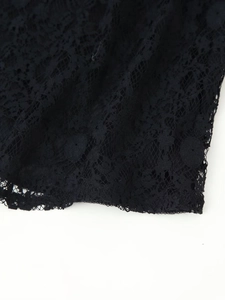 Detailed view of intricate floral lace texture with hollowed-out mesh pattern in black
