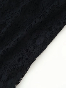 Close-up of black floral lace fabric with intricate mesh patterns and delicate hollow texture