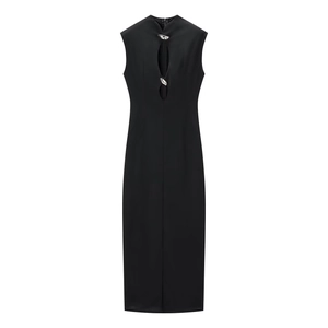 Detail of hollow-out front design and silver irregular metal buttons on a black dress