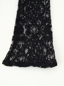 Detailed close-up of intricate black hollow-out floral lace texture on flared sleeve cuff