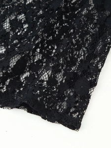 Close-up of black floral lace fabric with intricate hollow-out mesh patterns and textures