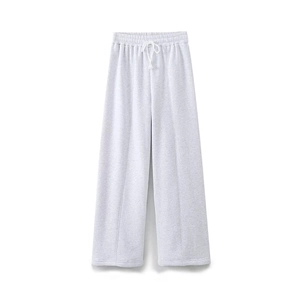 Detail of light gray wide-leg joggers featuring elastic waist, drawstring and seam lines