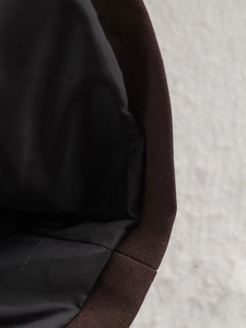 Detailed close-up showing the robust dark brown canvas texture and precise inner stitching