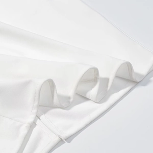 Close-up of white fabric hem showing neat stitching and smooth material texture