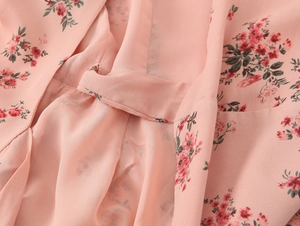 Close-up of pink floral chiffon fabric showing detailed stitching and light texture