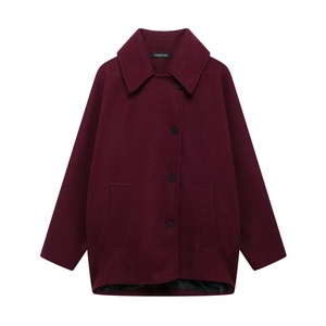 Detail of burgundy wool coat with notch lapels, black buttons, and side pockets