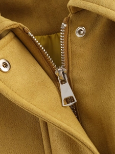 Detail of ginger suede bomber jacket featuring metal zipper and silver snap buttons