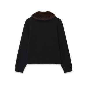 Detail of the back view of a black knit cardigan with a plush brown faux fur collar