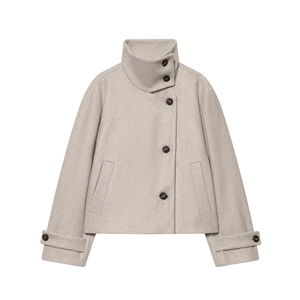 Detail of oatmeal wool coat featuring asymmetrical button closure and standing collar