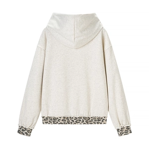 Oatmeal hoodie detail featuring leopard print cuffs and hem with knitted cotton texture