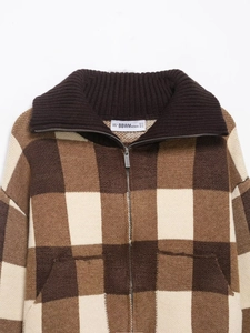 Detailed view of the brown plaid knit texture and dual zipper on the lapel cardigan