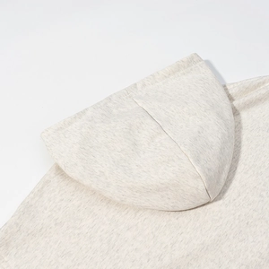 Detailed macro view of the soft oatmeal grey flecked knit fabric and hood texture