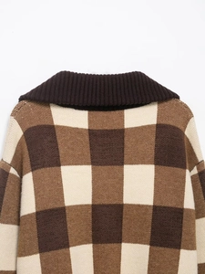 Close-up of brown checkered knit sweater showing retro collar and textured fabric