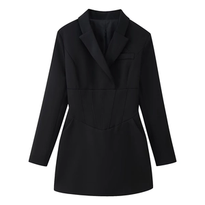 Detail of waist-cinching corset structure on a black long-sleeve blazer dress