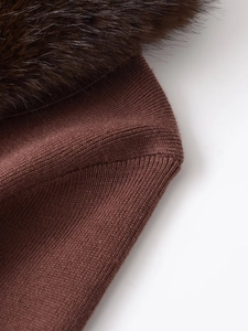 Detailed macro view of dark brown ribbed knit fabric with soft faux fur collar texture