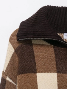 Detail view of the ribbed brown collar and metallic zipper on plaid knit sweater