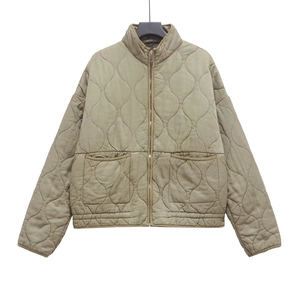 Detail of wave-quilted tencel cotton jacket featuring stand collar and zipper closure