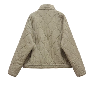 Detail of onion quilted back design on olive green tencel cotton jacket with ribbed hem