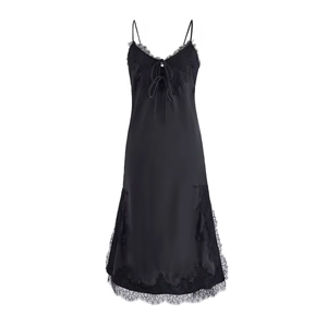 Detail of black silk satin slip dress featuring delicate eyelash lace trim and front bow