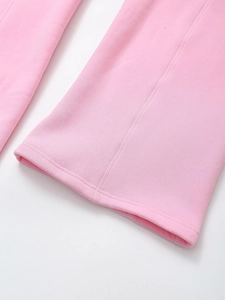 Detailed macro shot of pink wide-leg trouser hem with high-quality flat-lock stitching