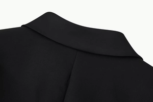 Detailed view of the black blazer dress collar and high-quality woven fabric texture