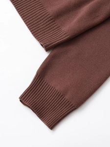 Detailed close-up of dark brown ribbed knit sleeve cuffs showing fine stitching and texture