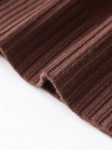 Detailed macro shot of brown ribbed knit fabric texture on a winter sweater collar
