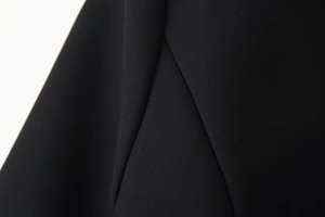 Macro shot of high-quality black woven fabric texture on the belted blazer dress