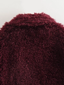 Detailed close-up showing the thick burgundy faux fur texture of the winter coat material