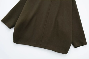Detailed back seam and textured olive green wool blend fabric of the winter coat