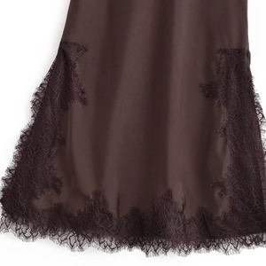 Detail of coffee satin dress featuring intricate eyelash lace trim and silky texture
