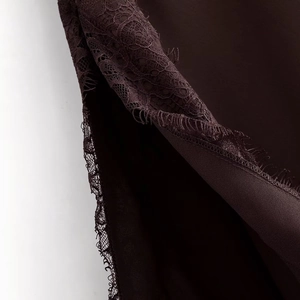 Detailed view of chocolate lace trim and eyelash fringe on a midi slip dress
