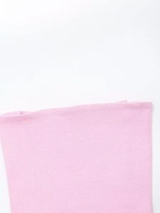 Close-up of pink ribbed knit fabric texture showing vertical patterns on 3-piece set