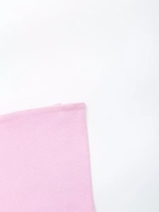 Close-up of pink ribbed knit fabric texture showing elasticity and soft material details