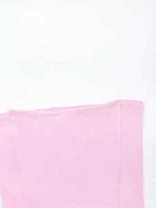 Detailed macro shot of pink ribbed knit fabric edge from a three-piece lounge set