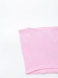 Detail view of pink ribbed knit fabric showing stretchy texture and seamless hem finishing